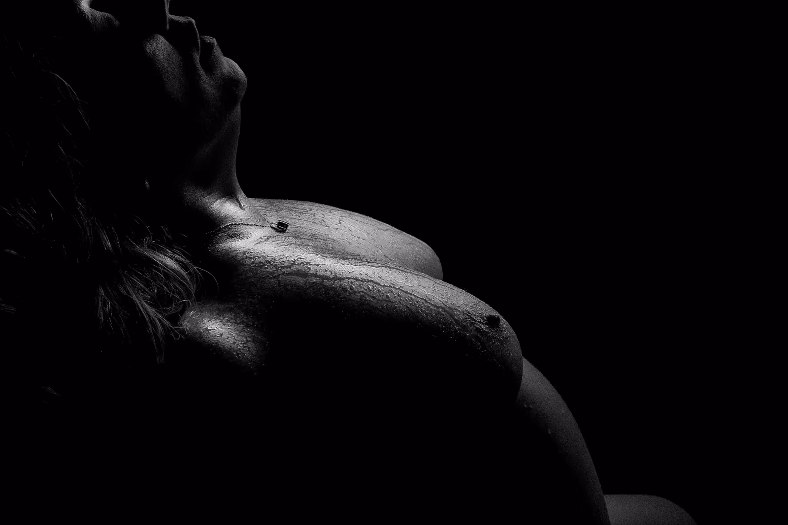 A powerful shadow-play portrait of a woman reclaiming her power at Boudoir By RDMimagery.